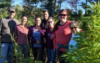 A group of people posing for a photo in a field.