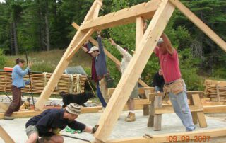 A group of people Building a barn