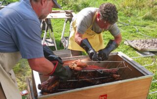 Two people preparing meat together